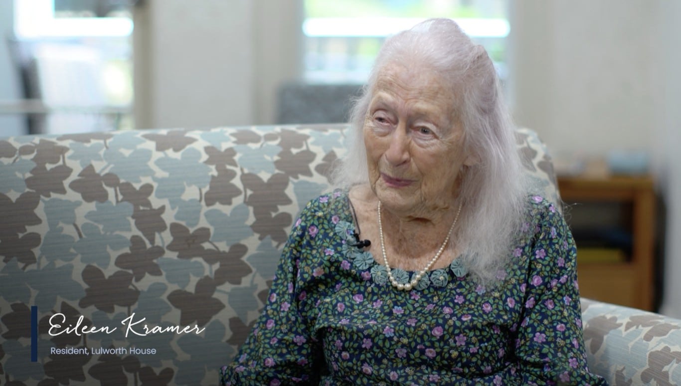 Beautiful older woman in conversation sitting on lounge